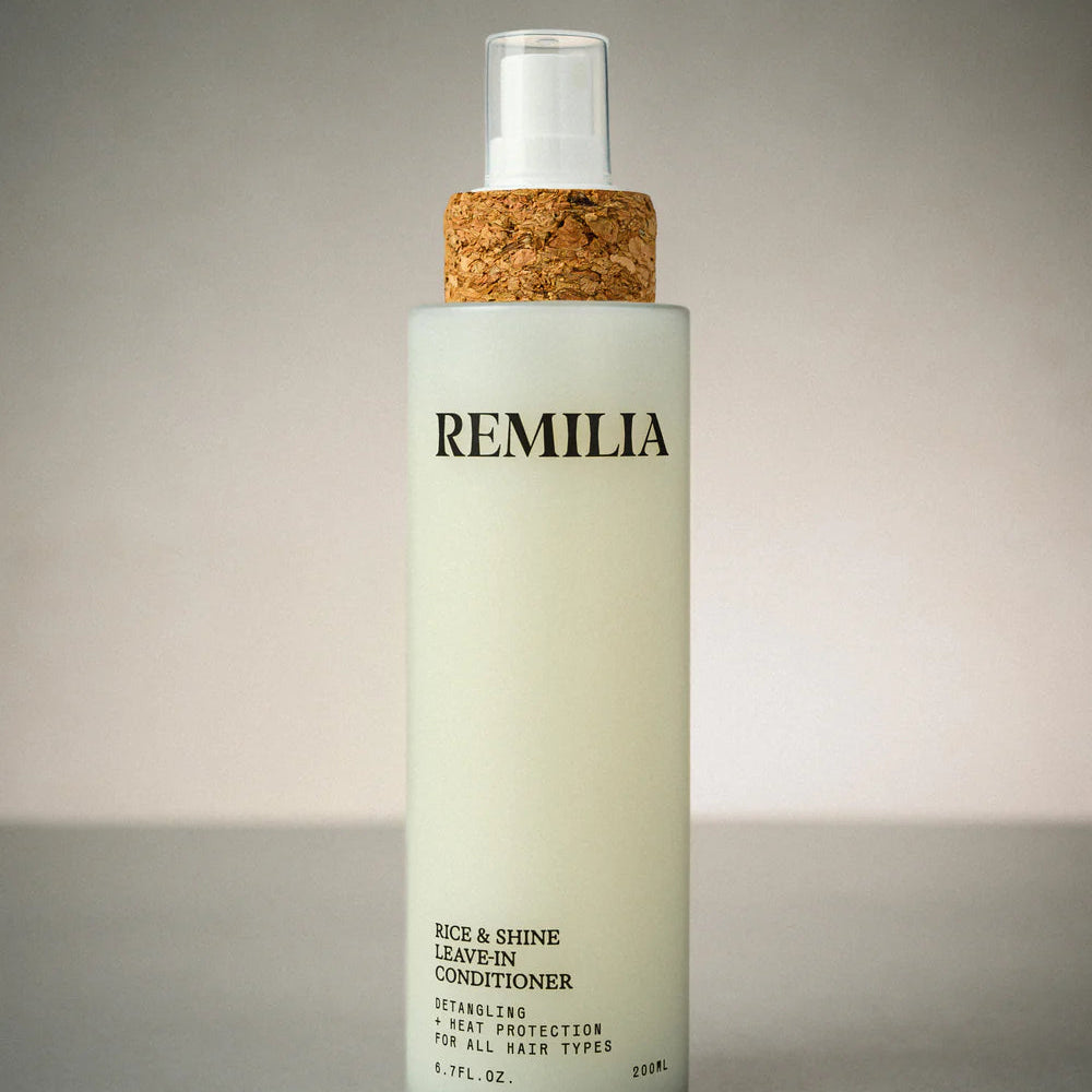 Bottle of Remilia leave-in conditioner with cork cap on a gray background