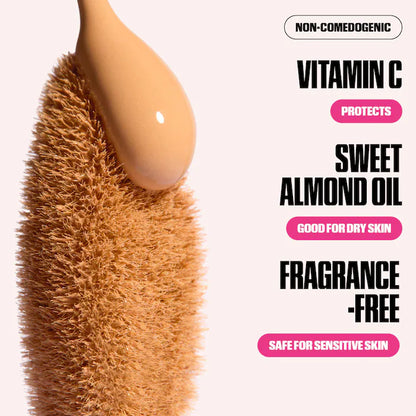 Product with a spoonful of cream on a textured surface, featuring text about product benefits.