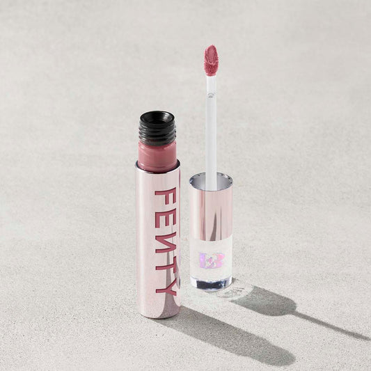 Fenty lip gloss with applicator on a light gray background
