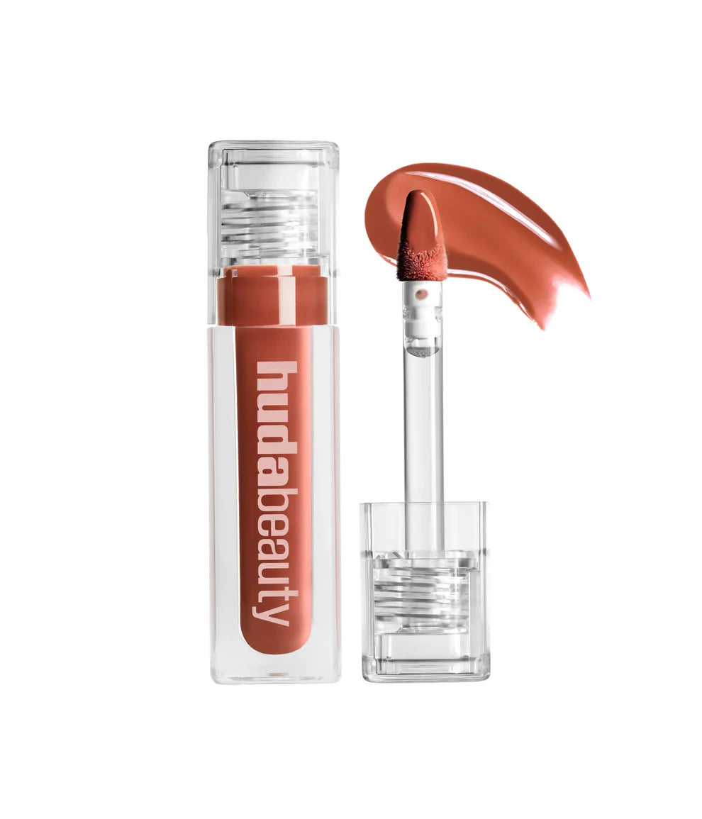 Lipstick with clear casing and 'hudabeauty' branding on a white background