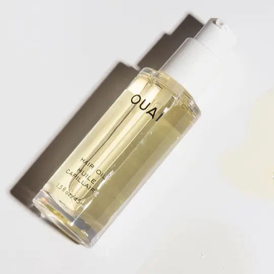 OUAI hair oil bottle on a white background